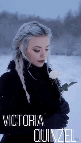 a woman holding a white rose with the name victoria quinzel above her