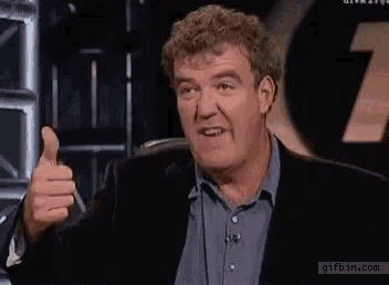 a man in a suit giving a thumbs up with gifbin.com in the corner