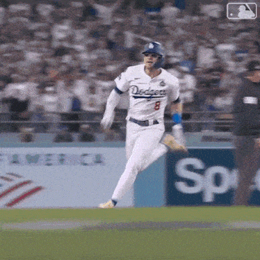 a baseball player wearing a dodgers uniform is running on the field .