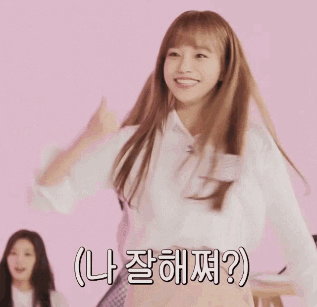 a girl in a white shirt is giving a thumbs up in a pink background