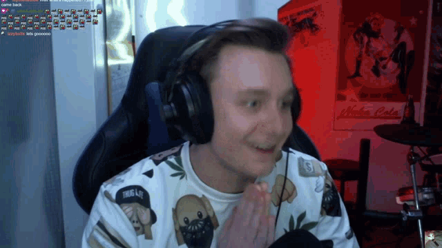 a man wearing headphones is sitting in front of a sign that says " nuka cola "