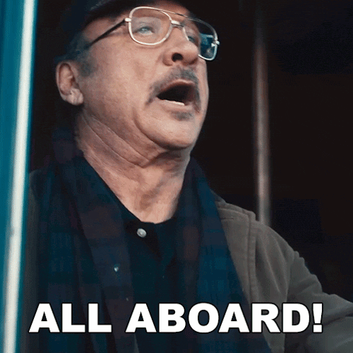 a man with glasses and a mustache is shouting all aboard
