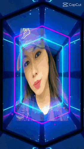 a woman wearing a la dodgers hat is surrounded by neon lights .