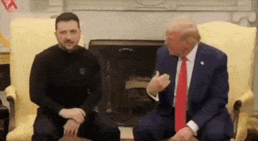 two men are sitting on a couch talking to each other .