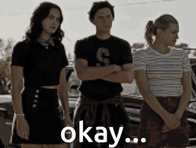 a group of people standing next to each other with the word okay on the bottom right