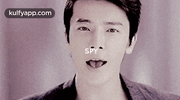 a close up of a man 's face with his tongue hanging out and the word spy written on it .