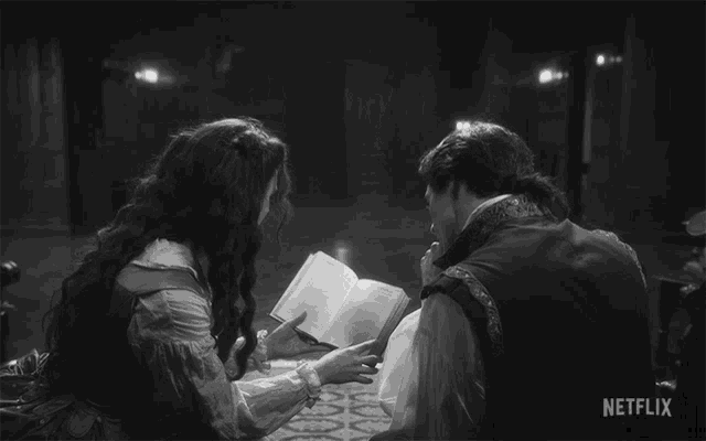 a black and white photo of a man and a woman reading a book with netflix written on the bottom