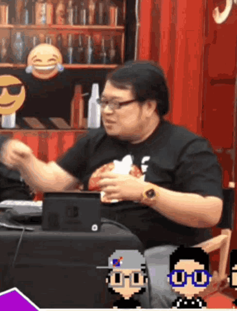 a man sitting at a table with an nintendo switch