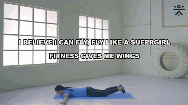 a woman laying on a yoga mat with the words i believe i can fly fly like a supergirl