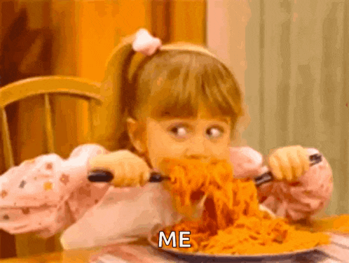a little girl is eating spaghetti with a fork and knife and says me on the plate