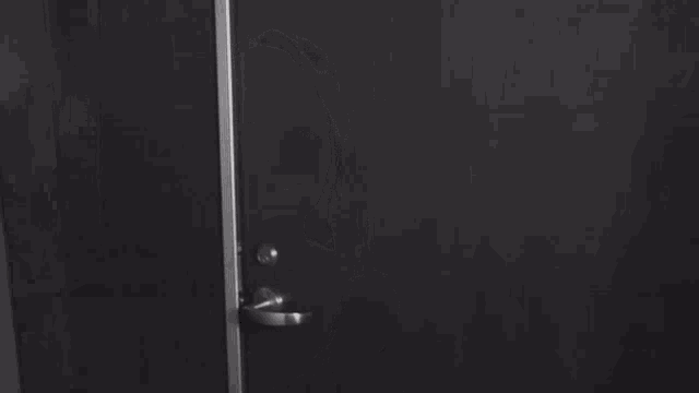 a woman in a bra is standing in front of a door