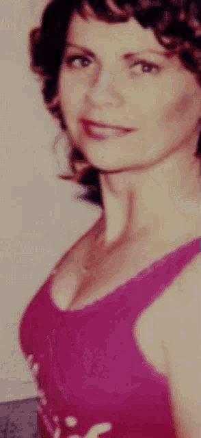 a woman in a pink tank top with the letter s on the front