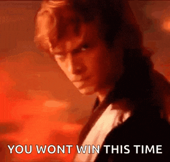 a man in a tuxedo is standing in front of a red background and says `` you won t win this time '' .