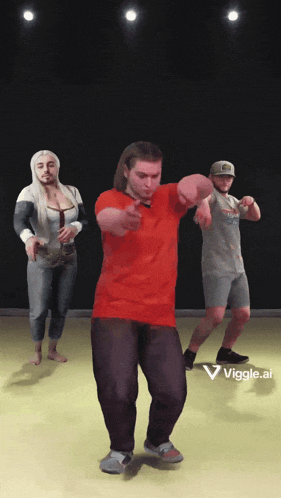 a man in a red shirt is dancing with a woman and a man in a gray shirt