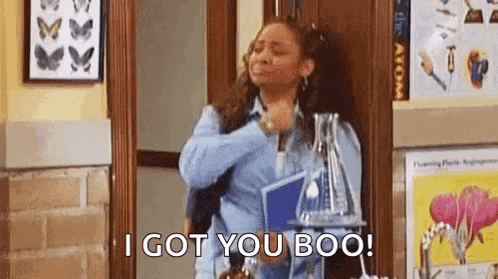 a woman is standing in a hallway holding a book and a bottle of water and making a face .