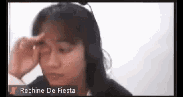 a woman crying on a video call with the name richine de fiesta