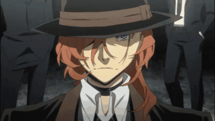 a man with red hair is wearing a fedora hat