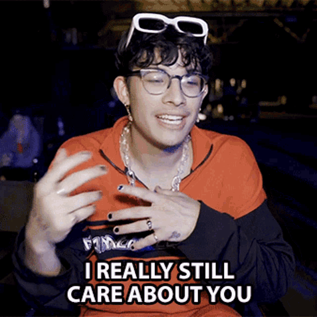 a young man wearing glasses and a shirt that says i really still care about you