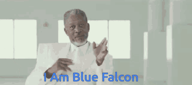 a man in a white suit and tie says " i am blue falcon "
