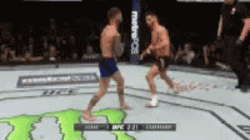 two men are fighting in a boxing ring in front of a monster energy logo .