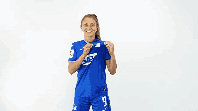 a woman wearing a blue shirt that says sap