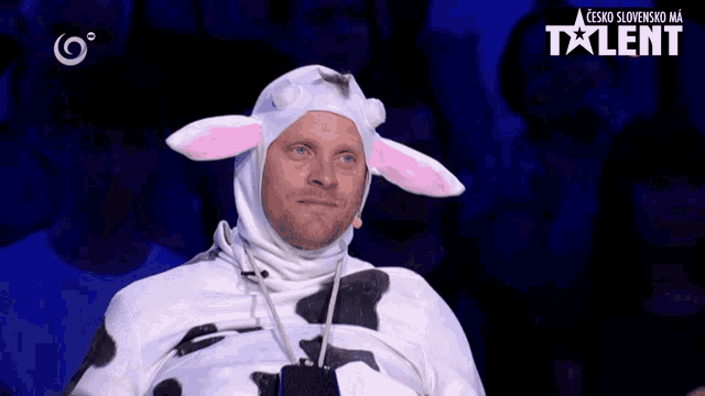 a man in a cow costume is on a talent tv show