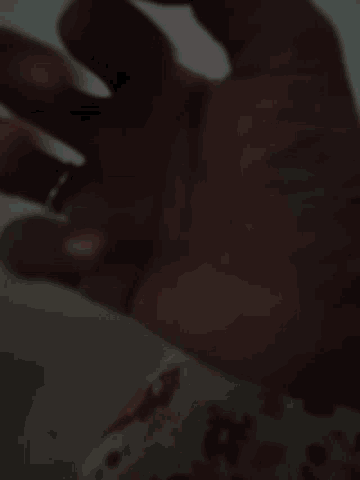 a close up of a person 's hand with a ring on it