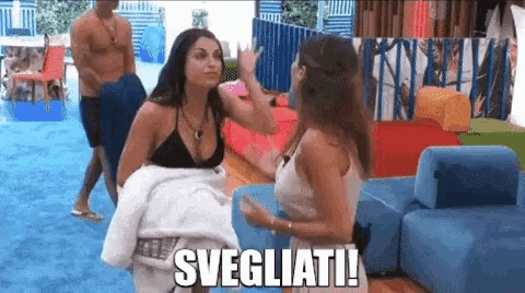 two women are standing next to each other in a room with the word svegliati written on the bottom
