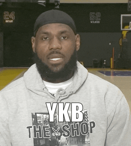 a man with a beard wearing a ykb the shop shirt