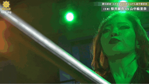 a woman in a red dress stands in front of a light that says fpw mg