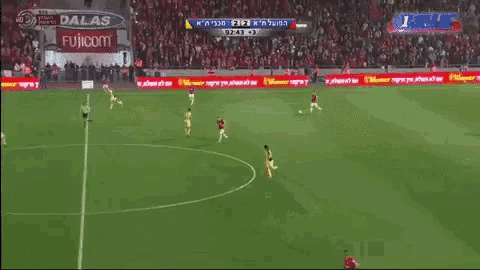 a soccer game is being played on a field with ads for dallas fujicom and others