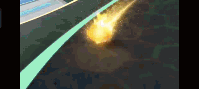 a yellow object is flying through the air with a blue line behind it