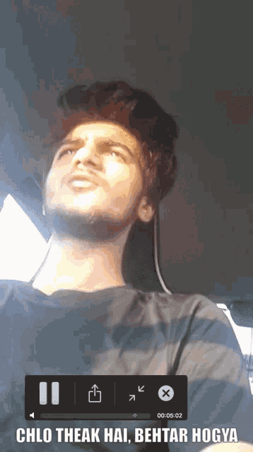 a man is sitting in a car with the words cho theak hai behtar hogya on the screen
