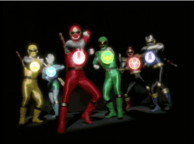 a group of power rangers are posing for a picture with glowing circles around them
