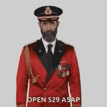 a man with a beard is wearing a red military uniform and a black hat .