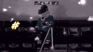 a sharks mascot is sitting in the stands with a cane