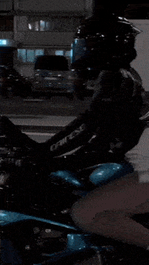 a woman wearing a helmet is riding a motorcycle