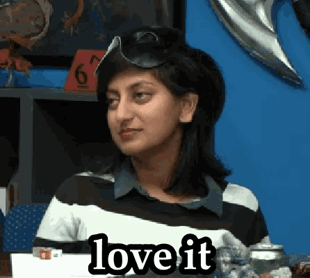 a woman wearing a pirate hat is sitting at a table and says love it