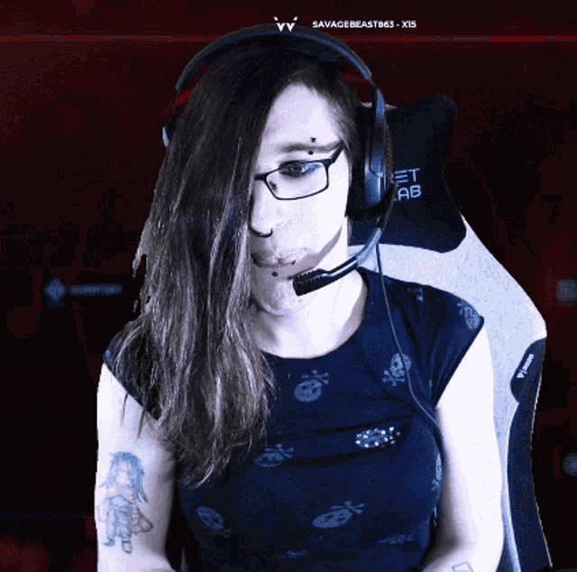 a woman wearing headphones and a shirt with skulls and crossbones on it