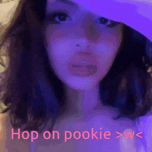a girl wearing a purple hat says hop on pookie