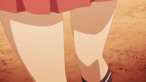 a close up of a person 's legs with a red skirt on