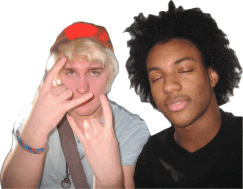 two young men are posing for a picture and one is making a devil horns sign
