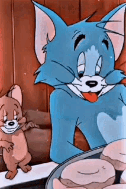 tom and jerry from the cartoon tom and jerry are sitting next to each other .