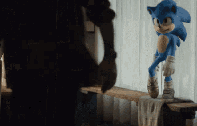 a sonic the hedgehog doll is standing on a bench
