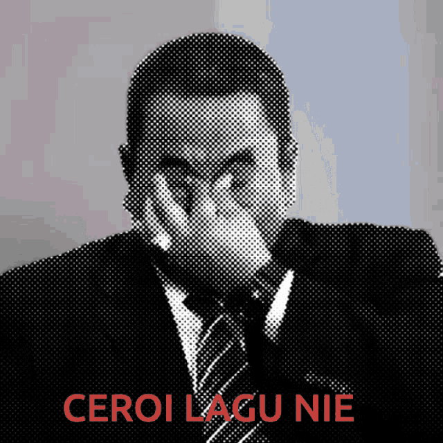 a man in a suit and tie is covering his face with his hand and the words " ceroi lagu nie " are above him