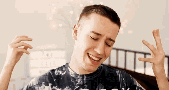 a man wearing a shirt that says ' abercrombie & fitch ' on it is making a funny face
