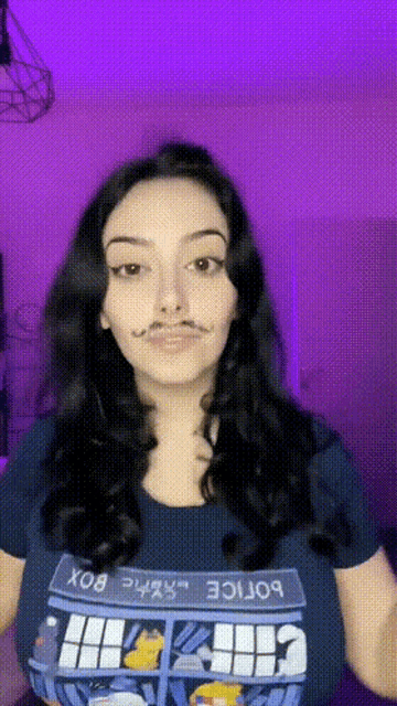 a woman wearing a police box t-shirt has a fake mustache on her face