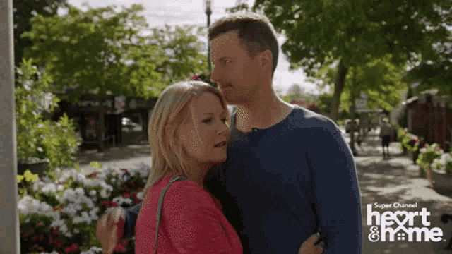 a man and a woman are standing next to each other on a sidewalk with the words next & me on the bottom