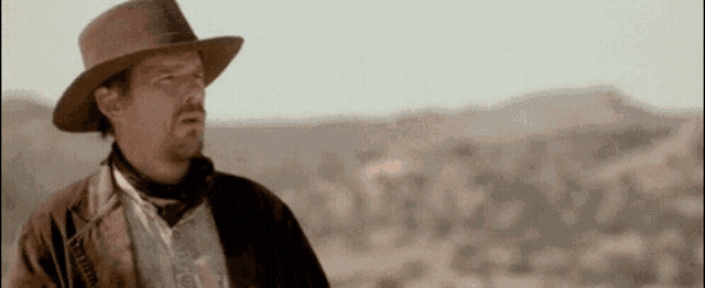 a man wearing a cowboy hat and a leather jacket