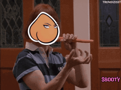 a woman holding a carrot with a cartoon face on her face and the words $booty below her